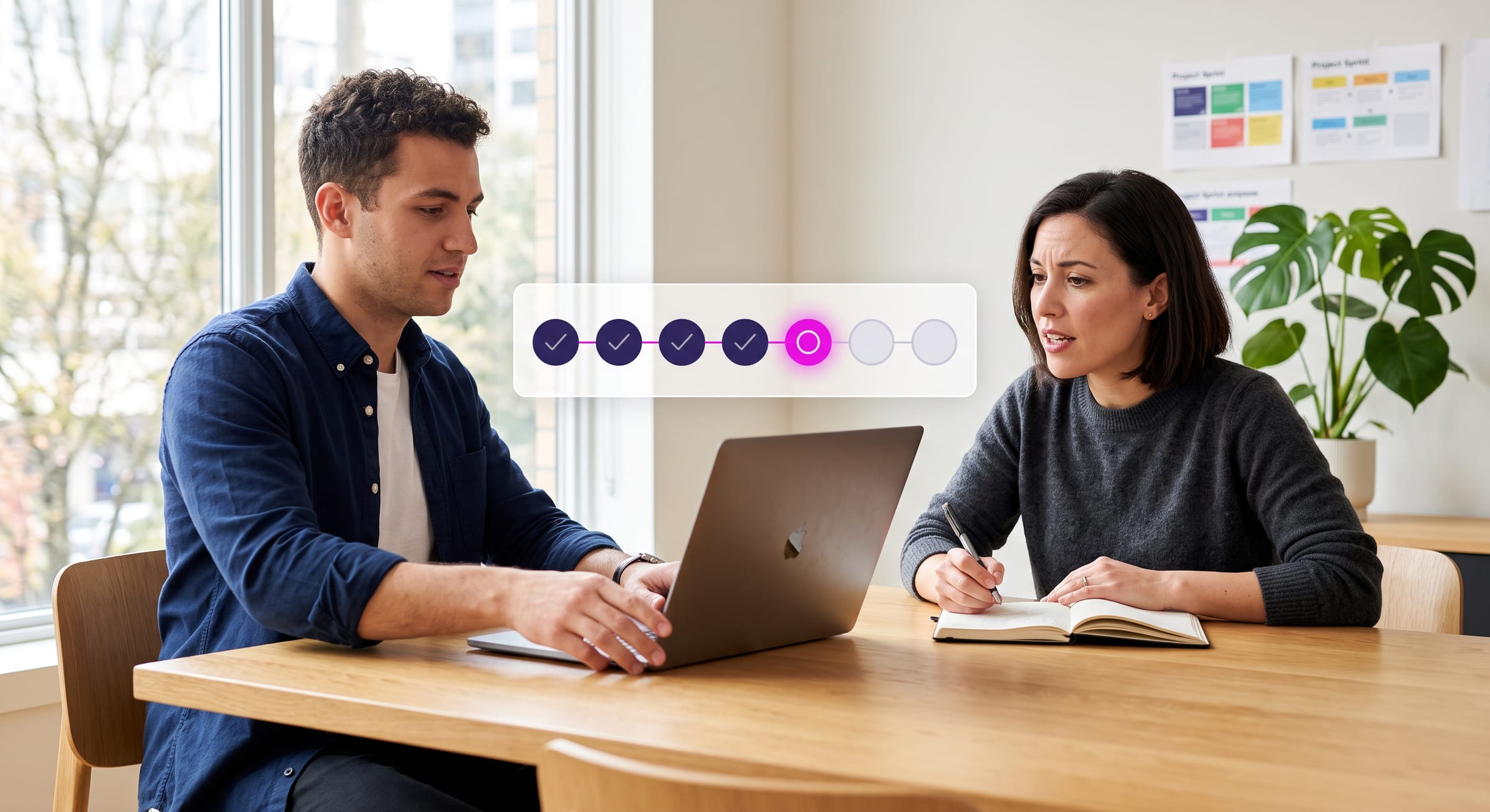 Two agency colleagues across a table, one turning a laptop toward the other who is taking notes, with a row of seven chips beside them and four of them ticked.